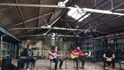 Young people socially distanced and playing various instruments outside